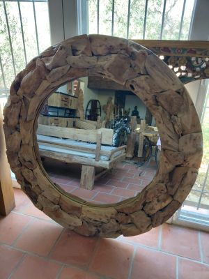 a mirror that is sitting on a table in a room