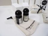 three bottles of perfume sitting on a table next to a bag