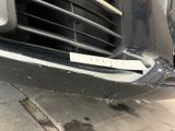 a sticker on the front of a car that is parked on the side of the road