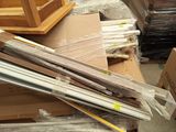 a pile of boxes and a picture frame on the floor