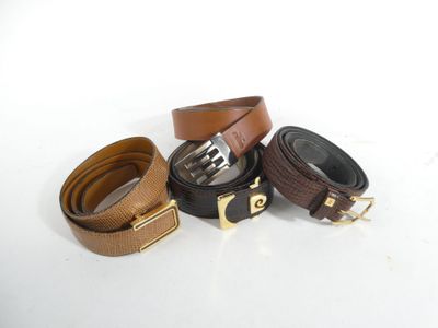 three belts with gold buckles on a white surface