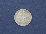 a close up of a silver coin on a blue cloth