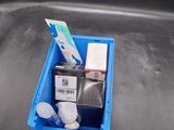 a blue container with toothbrushes and toothpaste in it