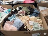 many boxes of clothes that are sitting on the ground