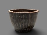 a black and white bowl on a gray surface