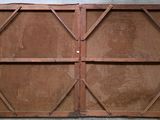a brown wooden door with a metal frame