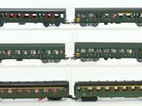 four different views of a green train car on a white surface