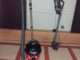 a black and red vacuum sitting on the floor next to a red and white checkered floor