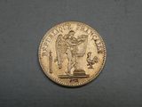 a close up of a coin with a statue on it