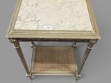 a marble topped table with wicker shelf