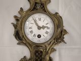 a clock that is on the wall with a bird on it