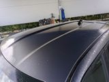 a black car parked in front of a garage