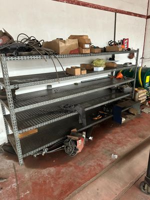 a metal shelf with many items on it in a garage