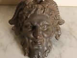 sculpture of a man ' s head on a marble counter top