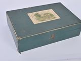 a green box with a picture on it sitting on a white surface