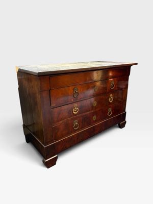 an antique chest of drawers with marble top and brass handles