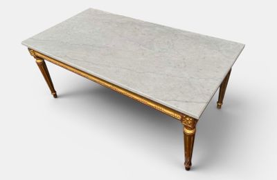 a white marble top coffee table with gold legs