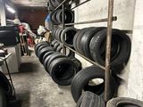 a lot of tires on a shelf in a garage