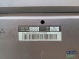 the back of a laptop computer with a bar code on it