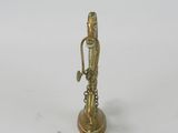 brass figurine of a man with a sword on a white background