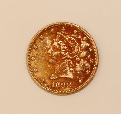a gold coin with the head of a woman on it