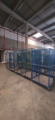 a large cage in the middle of a warehouse