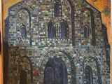 une peinture à l'huile représentant une église, encadrée et posée sur une table