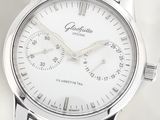 a close up of a watch on a white surface
