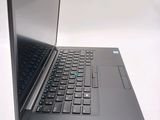 a laptop that is open on a white surface