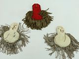 three pieces of cloth with a red hat on top of them