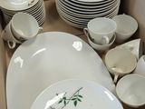 many plates and bowls in a box on the table