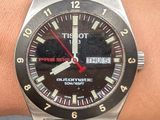 wrist shot of a watch on a person ' s wrist with a red second hand