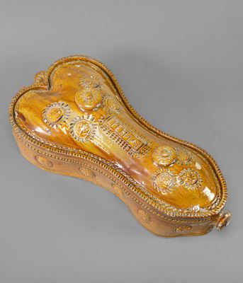an ornately decorated wooden box with a gold decoration on it