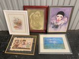 three framed pictures of a woman and a dog are on a table