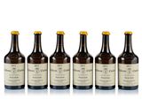 six bottles of wine are lined up on a white surface