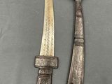 two antique silverware knives and a knife with a wooden handle