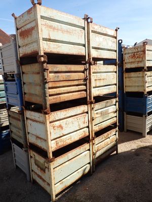 many crates stacked on top of each other in the dirt