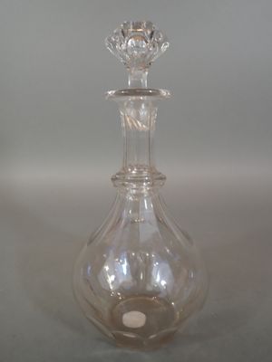 a clear glass bottle with a flower on the top of it