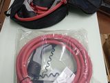 un tuyau rouge et un sac noir posés sur une table