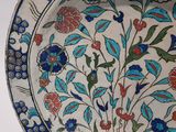 a plate with a floral design on it sitting on a table