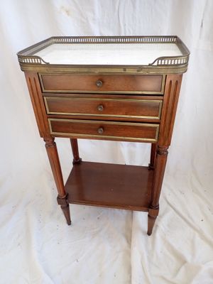 an image of a small wooden table with three drawers on top of it