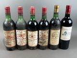several bottles of wine are lined up on a table
