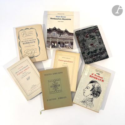 several books are arranged on a white surface with a white background
