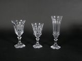 three crystal wine glasses on a black background
