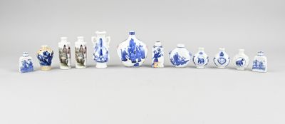 several blue and white vases are lined up on a white surface