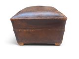 an old leather box on a white surface with a white background