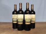 three bottles of wine sitting on top of a wooden table
