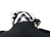 a man wearing a black jacket and a white and black checkered hat