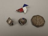 three silver and red pins and a silver and blue pin