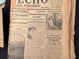 several old newspapers sitting on top of a table next to a cup of coffee